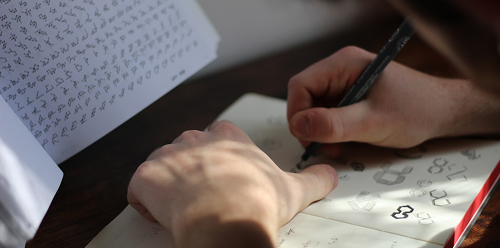 A designer sketching ideas in a notebook.
